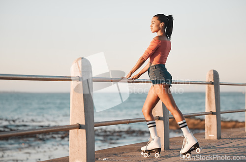 Image of Summer, roller skate and black woman at beach promenade for fitness freedom, fun exercise and hobby training. Relax, calm and sunshine nature with young skating culture, cool urban girl and sea youth