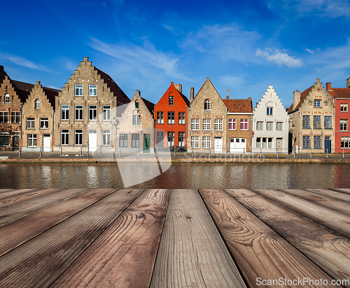 Image of Wooden planks table with European town in background