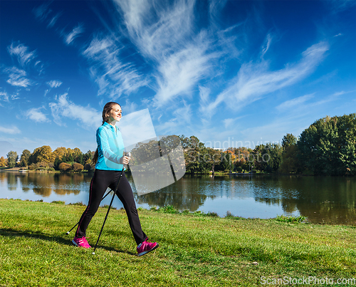 Image of Young woman nordic walking