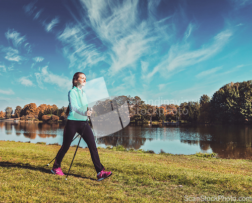 Image of Young woman nordic walking