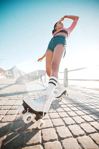 Image of Girl relax while roller skating, travel or journey on sidewalk for fitness, health and training exercise with flare. Woman on fun city adventure traveling on roller blades for workout bottom view