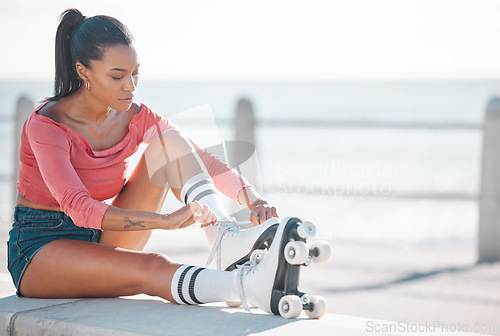 Image of Fitness, exercise and happy woman roller skating along a beach on a sunny day, content while prepare for workout outdoors. Active female enjoying free time with hobby, exercising and cardio with fun