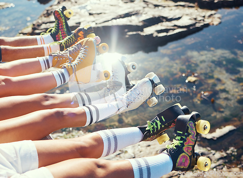 Image of Ocean and legs of friends with roller blade relax near lake, water or sea after adventure, journey or skate ride. Skating community, team and club or people meeting for fun beach group travel