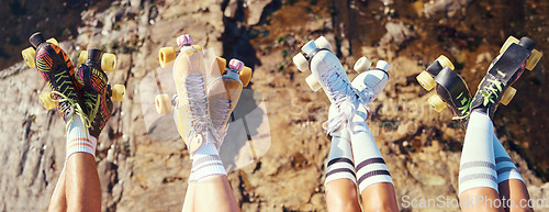 Image of Roller skates, fun and adventure travel with friends group lifting legs and showing off retro skating footwear while outside. Group of women enjoying hobby, freedom and activity on holiday together
