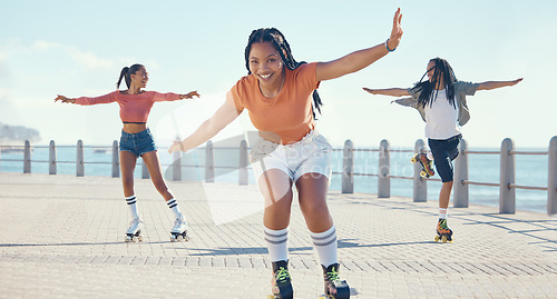 Image of Friends, fitness and roller skating at the beach in summer as a group of young gen z girls and boy skate in freedom. Smile, happy and active people riding blades on the promenade on holiday vacation