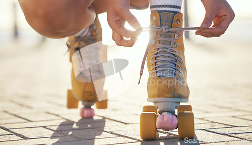 Image of Yellow roller skates shoes of woman in summer outdoor travel, journey or fun activity for the holiday. Cool, trendy or funky gen z person prepare or tie laces on ground in quad skating with sunshine