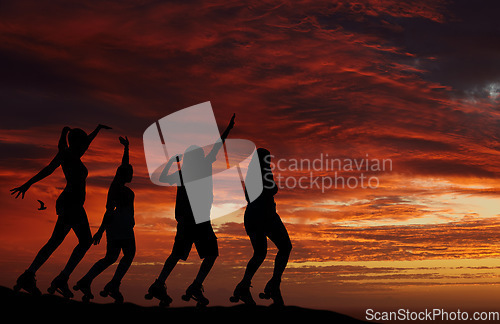 Image of Sunset, silhouette and roller skate friends out on an adventure or travel for fun while skating and watching horizon view with orange or red sky. Freedom, scenery and beauty of nature and friendship