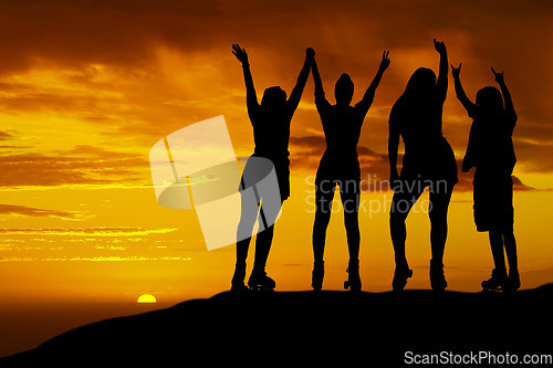 Image of Roller skating friends silhouette on hill with sunset sky horizon. Young, fitness or carefree people or gen z shadow at night with orange and yellow background sky for wellness, youth and adventure