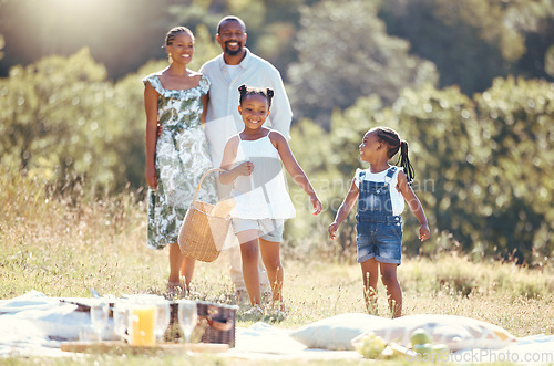 Image of Black family, summer picnic and children bond with parents on break in remote countryside park field. Smile, happy and love mother, father or playful and fun girls in nature outing with man and woman