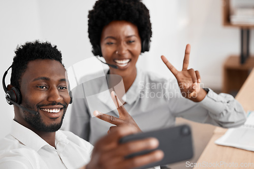 Image of Selfie, peace and friends in a call center with a consultant and colleague in customer support, telemarketing and sales. Contact us, crm and consulting with people taking a photograph in an office