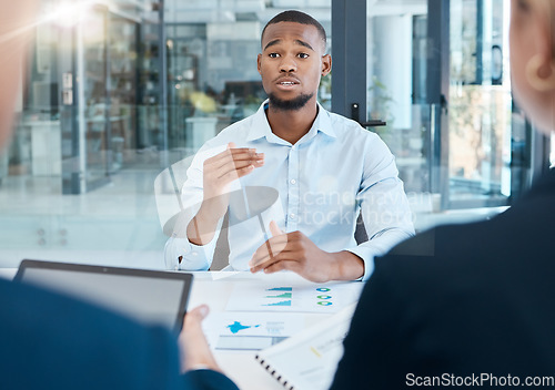 Image of Black man, interview and office presentation to business team on analysis, data and research. African man in corporate discussion explaining company strategy and analytics for innovation and goals