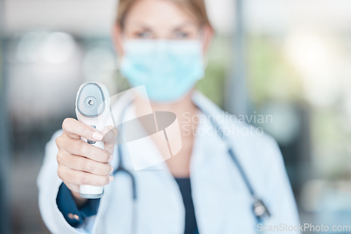 Image of Thermometer, covid face mask and doctor check temperature for hospital policy or compliance with bokeh. Medical healthcare worker with scan device for corona virus disease detection POV or portrait