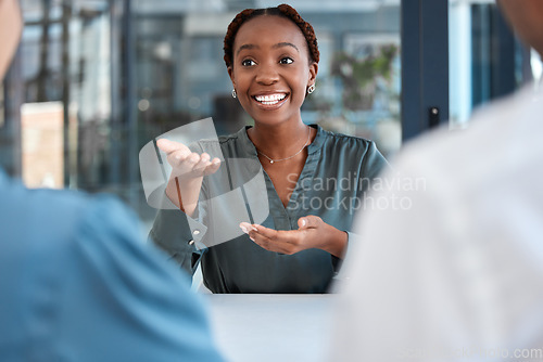 Image of Black manager, advisor or coach during business meeting while talking, speaking and explaining strategy or vision in office. African american woman planning and discussing collaboration with her team