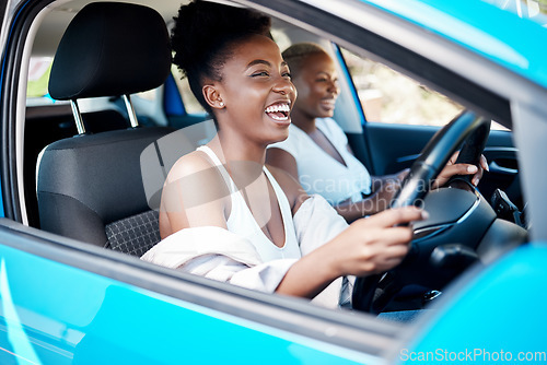 Image of Woman driving, friends and roadtrip for a fun and happy drive while enjoying their vacation, trip and journey together. Black women laughing and talking while sitting in car for an adventure or lift