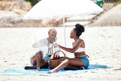 Image of Black women, friends and cheers with beer on a beach in nature on a hangout, vacation or holiday. Drinking, happy African girls and a smile with refreshing alcohol, beverage or liquor by the shore.