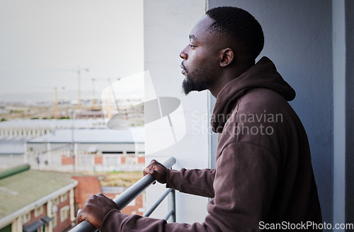 Image of Depressed, sad and thinking man with mental health problem on balcony, planning idea while in apartment with anxiety and burnout from depression. Fail, decision and African person think at house