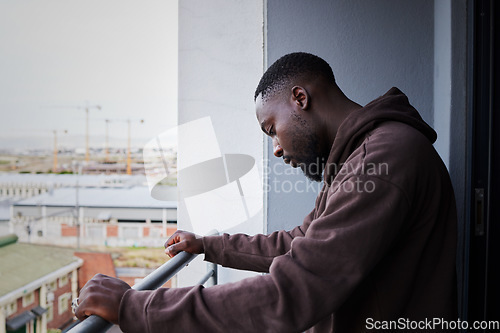 Image of Depression, sad and mental health with a man feeling anxiety, angry or frustrated out on a balcony alone. Fail, depressed and problem with a young male in grief or fear and having a difficult problem