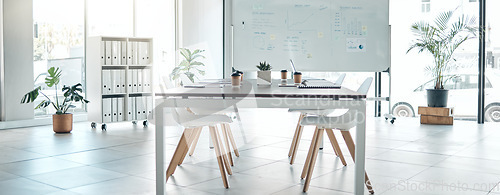 Image of Empty boardroom, conference or meeting room with table, chairs and whiteboard. Business presentation office, corporate company interior space and furniture in modern workplace for discussion.