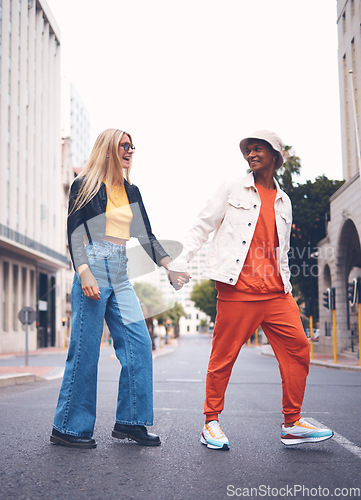 Image of Happy interracial couple with fashion clothing in a urban city street with a smile and love. Trendy, stylish or punk man and woman walking in a town road with funky, edgy and style together