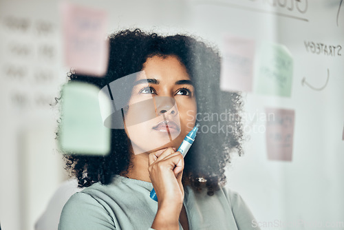 Image of Thinking of marketing strategy on sticky note, post it paper for planning creative advertising idea and thinking of reminder on glass board. Business woman with plan for startup company at work