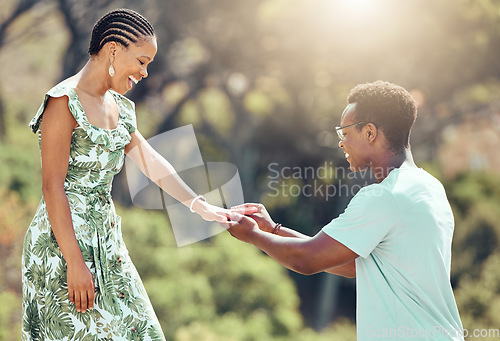 Image of Love, engagement and black man propose to girlfriend on romantic date outdoors, happy and excited. African woman surprise sweet gesture, enjoying special relationship moment on outdoor date together