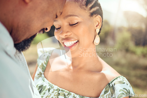 Image of Love, black couple and forehead touch in nature with a smile on holiday or date. Happy black man and woman, romantic African people or lovers bonding in affection together in the shining summer sun.