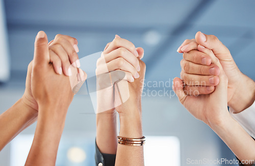 Image of Teamwork, hands and motivation with a team of people working in collaboration and celebration of success in an office at work. Support, trust and cheering with a group cheering or saying yes together