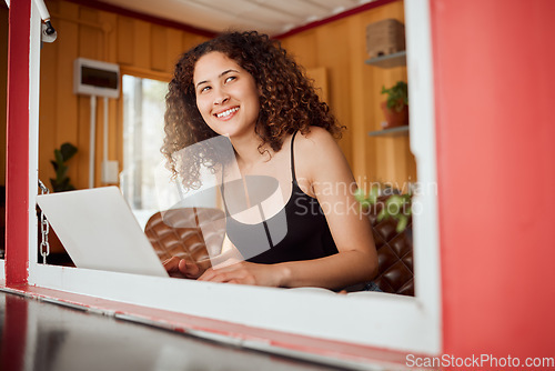 Image of Lady working on a laptop while looking out the window of her modern, trendy and edgy house. Smiling, positive and young female student with an afro browsing on technology while thinking and learning
