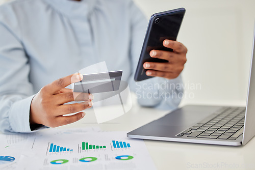 Image of Finance, accounting and trading with a businessperson using a phone and credit card in her hands and a graph on the desk. Fintech, investment and banking with a female employee managing money online