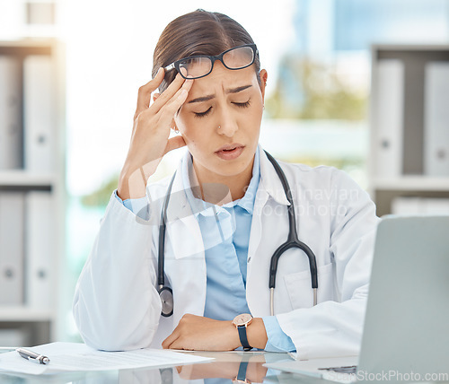 Image of Headache pain, tired doctor and burnout stress from working in a medical hospital, problem consulting online with laptop and anxiety from healthcare work. Sad nurse thinking of consultation in office