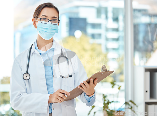 Image of Medical doctor, covid hospital office and healthcare worker with face mask. Consulting clinical medicine advice, corona virus results on clipboard and nurse working in professional protection.