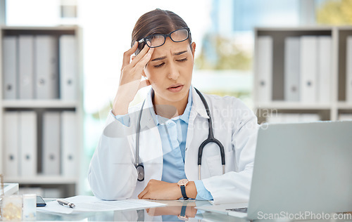 Image of Headache stress, doctor burnout and sad nurse working on laptop in work office at hospital, tired from consulting in healthcare and anxiety from medical surgery. Worker with depression at clinic