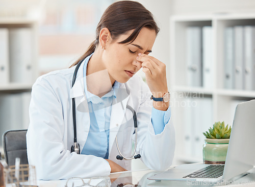 Image of Headache pain, doctor stress and burnout from hospital work on laptop, sad about mental health problem and anxiety working in healthcare. Tired medical nurse with depression and mistake at clinic