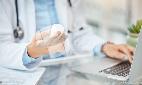 Image of Pharmacist or doctor with prescription medicine bottle and laptop working on pills medical healthcare research. Hands of man cardiologist or professional pharmacy expert typing in antibiotics results