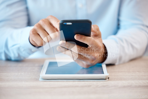 Image of Internet, technology and communication, a man with phone in hand and tablet on desk. Businessman online in contact with client, reading email or browsing social media. Fintech, ux and payment via app