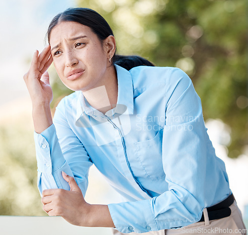 Image of Stress, anxiety and headache by woman employee suffering with pain, unhappy and holding her head outdoors. Young corporate worker looking exhausted, experience burnout and pressure at the workplace