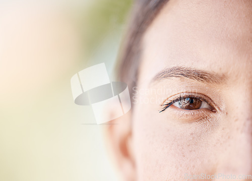 Image of Face portrait of a woman eye thinking with mockup or blurred background with bokeh. Head of a serious or focus young female with light freckle skin, staring with brown eyes outdoors in nature