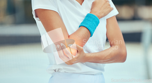 Image of Tennis elbow, pain and injury with a sports woman holding her joint during training, workout and exercise. Fitness, health and accident with a female athlete in a game or match on a court outside