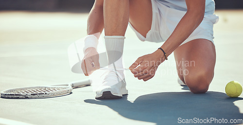 Image of Tennis sports athlete tie shoes to prepare for exercise, fitness or competition training on tennis court. Player or man hands tying shoelaces ready for game, tournament or health performance workout