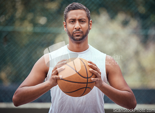 Image of Basketball court, man and serious portrait with ball in outdoor sports venue for practice. Competitive, strong and mature athlete male thinking of a game play strategy for outside match.