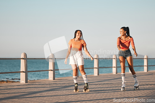 Image of Friends roller skating on the promenade at the beach during a summer vacation in South Africa. Happy, active and young girls doing a fun activity in nature on the ocean boardwalk while on holiday.