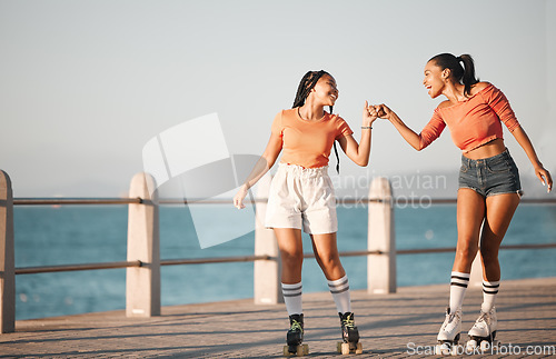 Image of Girl, women or friends roller skate on sea, water or ocean sidewalk together for fun travel and relax adventure ride. Fist bump, friendship and journey for fitness, exercise and skate training cardio