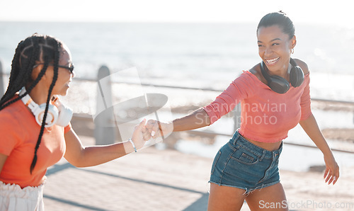 Image of Freedom, friends and headphones with women roller skate at the promenade together by the sea for fun. Relax, music and summer with young females skating by the beach for wellness and bonding