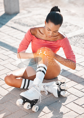 Image of Roller skate and sports knee injury for girl hurt on the floor after travel, ride and skate on sidewalk. Emergency, accident and training woman learning to roller blade hurt on the ground after fall