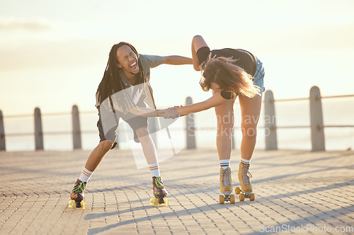 Image of Freedom, fun and happy couple laughing and roller skating outdoors together, positive, playful and cheerful. Excited interracial boyfriend and girlfriend being crazy while enjoying skate practice