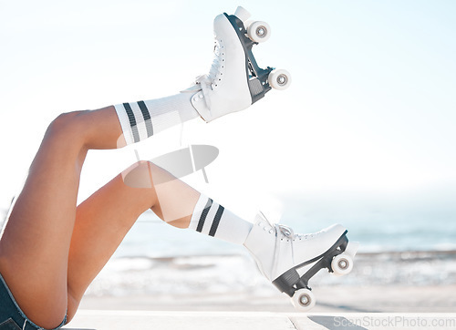 Image of Roller skates, travel and summer vacation and beach fun with woman enjoying hobby, relax and freedom while skating. Legs and retro footwear of a fit female skater out for active adventure by the sea