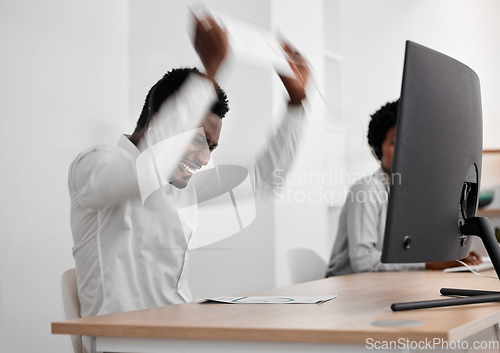 Image of Stress, angry and frustrated African businessman working on a computer in a modern company office. Aggressive, corporate and black employee upset about broken desktop while doing an online project.