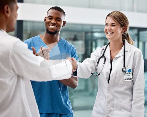 Image of Handshake with doctors at a hospital, clinic or medical facility for good job, success or approval. Healthcare, health and thank you, shaking hands or clapping, congratulations or welcome onboard.