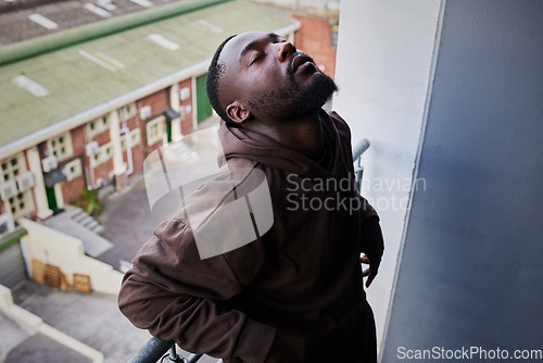 Image of Depression, mental health and anxiety for sad man suffering from life problem stress on balcony of home apartment. Depressed black person face with negative mindset, pain and frustrated over failure