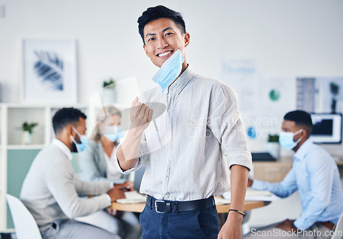 Image of Portrait of happy Asian businessman with a mask for end of covid or coronavirus in an office meeting with team. Leader, ceo or manager with a smile for collaboration, teamwork or teamwork success